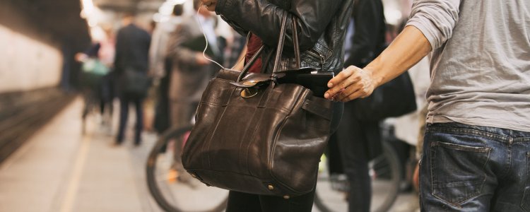 Thief stealing wallet at train station