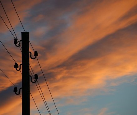 Phone mast against a colourful sky