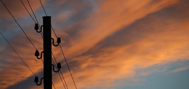 Phone mast against a colourful sky